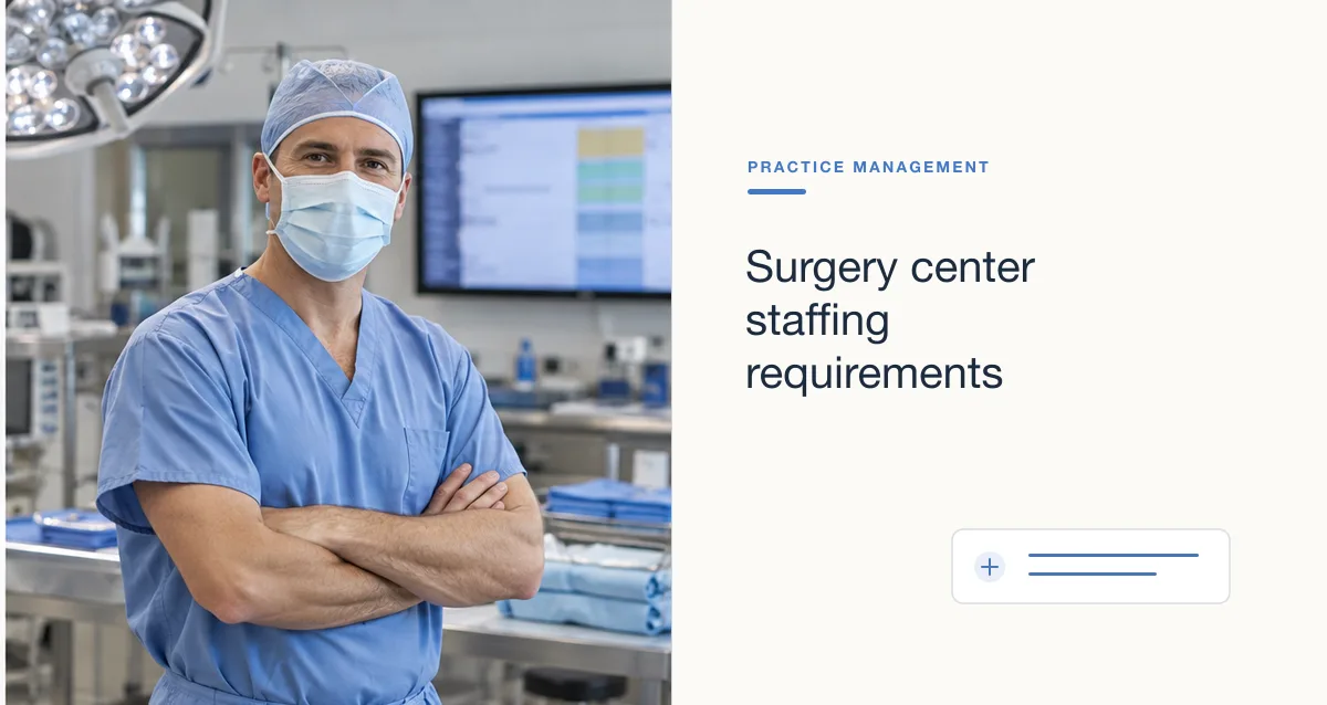 A surgeon in scrubs and a surgical mask stands with arms folded in an operating room.