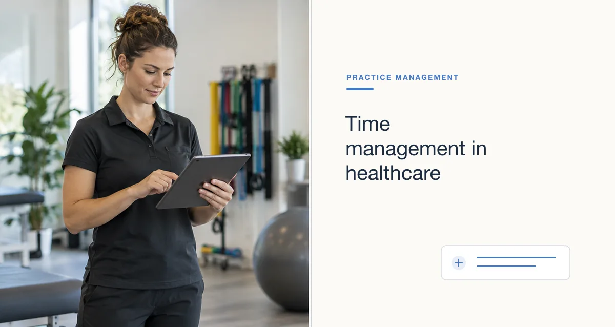 A clinician in a dark polo checks a tablet in a therapy gym.