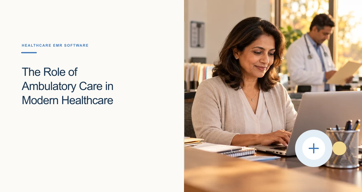 A South Asian clinic operations manager works on a laptop at a warm, organized front-office desk.