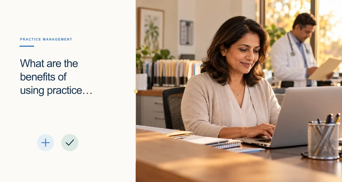 A South Asian clinic operations manager works on a laptop at a warm, organized front-office desk.