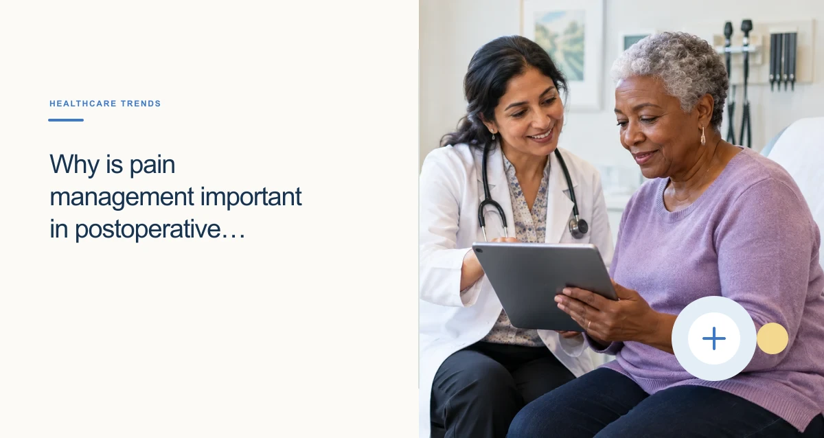 A South Asian physician helps an older Black woman use a tablet during a clinic visit.